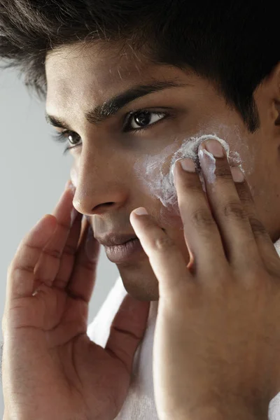 man washing face