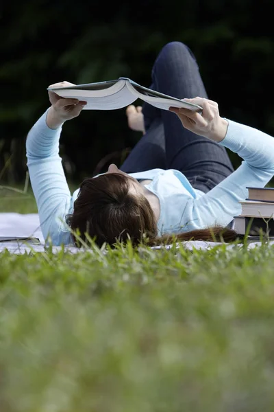Young woman lying down at the park