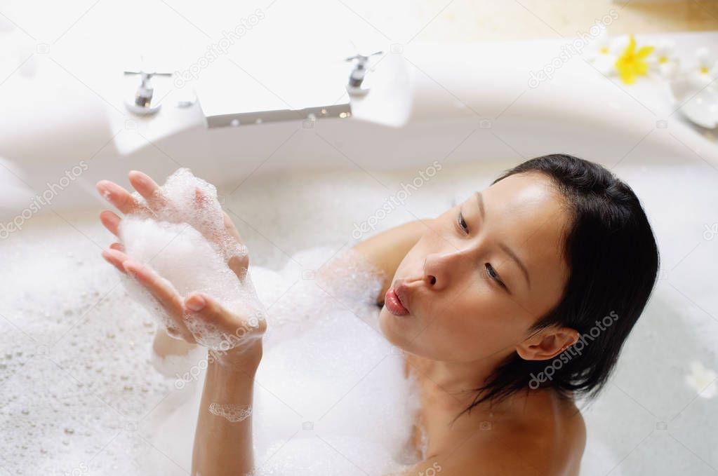 Woman in bathroom, taking at bath