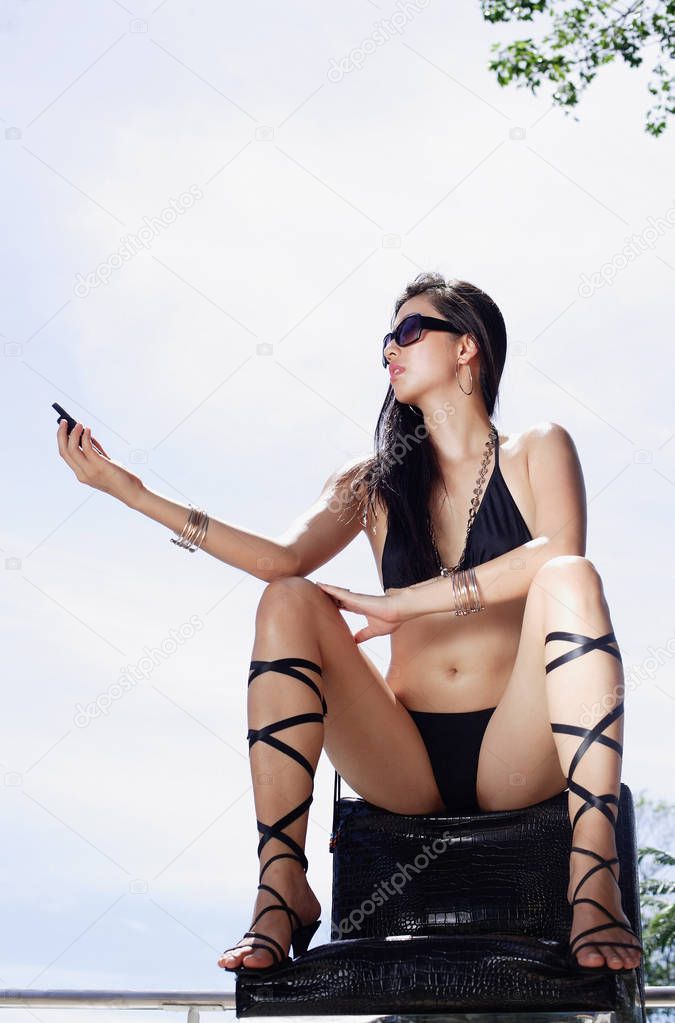 Woman in bikini, wearing high heels