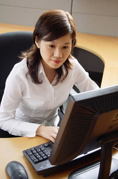 Businesswoman working in office cubicle