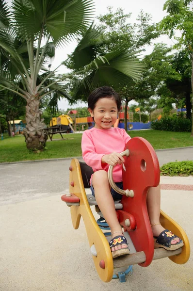 Jovem sentada no parque infantil — Fotografia de Stock