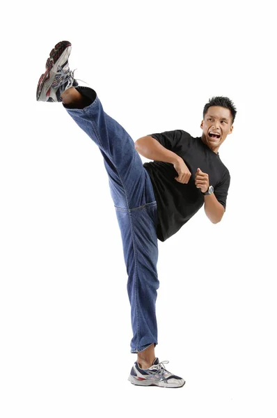 Young man kicking — Stock Photo, Image