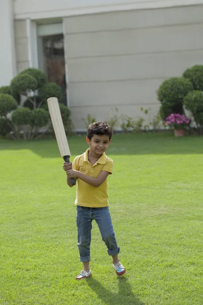 boy holding cricket bat