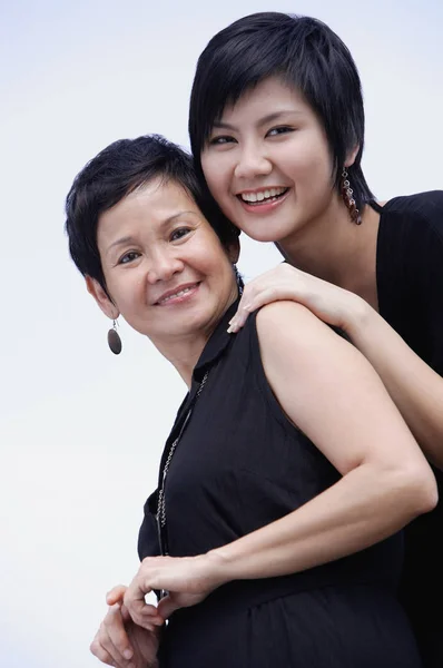 Mother and adult daughter smiling Stock Image