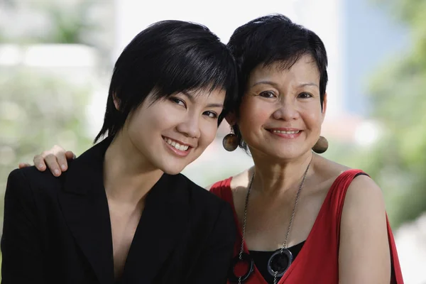 Mother and adult daughter looking at camera Stock Image