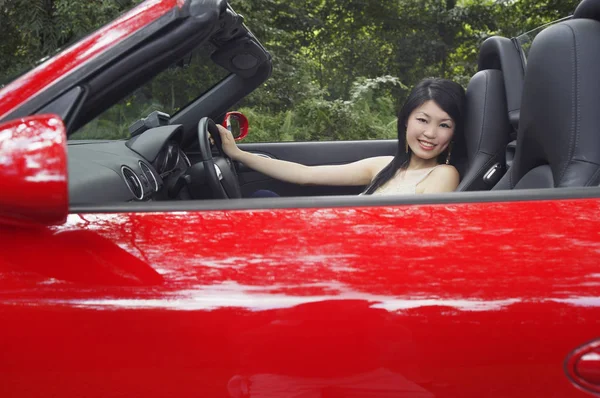 Woman in sports car