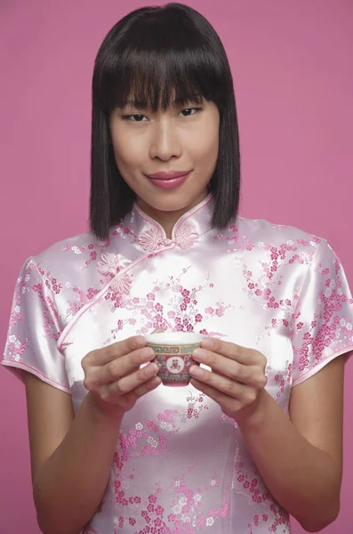 Woman holding Chinese tea cup