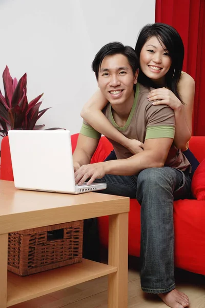 Couple in living room with laptop