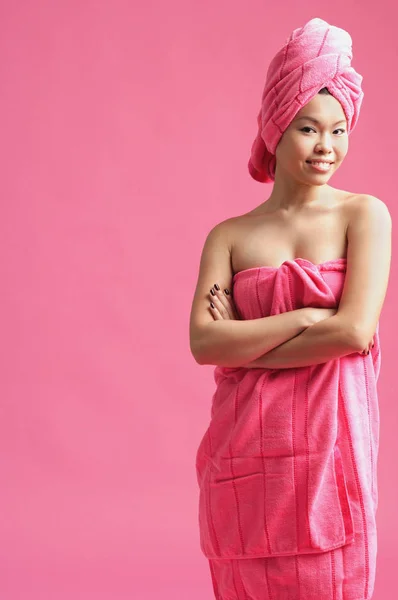 Woman wrapped in a pink towel