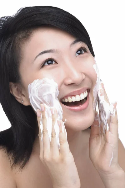 Woman putting facial cleanser — Stock Photo, Image