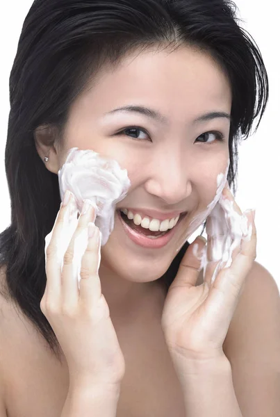 Genç kadın yüz temizleyici koyarak — Stok fotoğraf