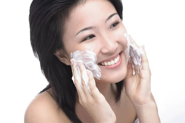 Woman lathering soap on her face — Stock Photo, Image