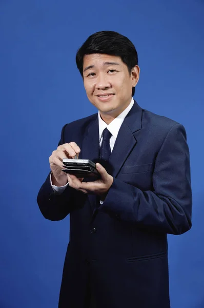 Businessman holding calculator — Stock Photo, Image