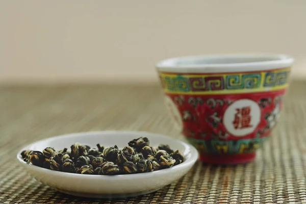 Chinese teacup and tea leaves