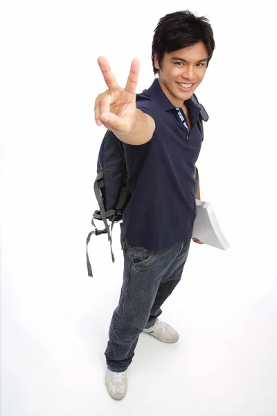 Young man carrying books — Stock Photo, Image