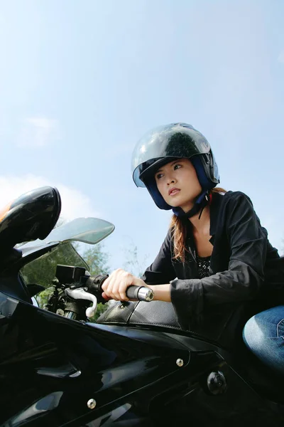 Young woman riding motorbike