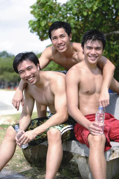 Three men without shirts