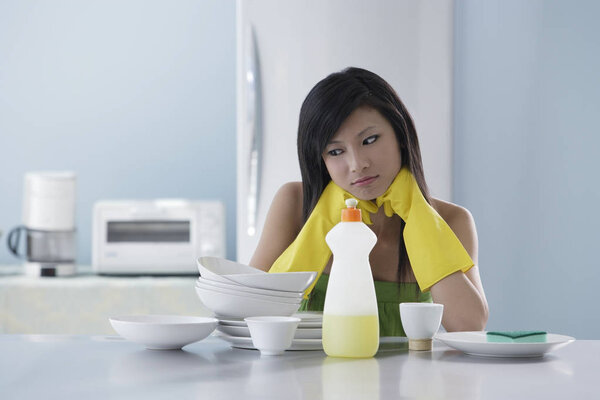 woman in kitchen, thinking