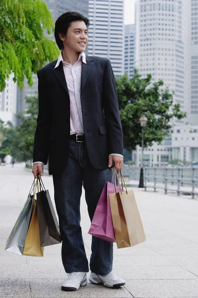 Man standing with shopping bags — Stock Photo, Image