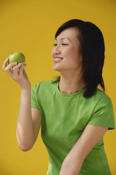 Mulher segurando maçã verde — Fotografia de Stock