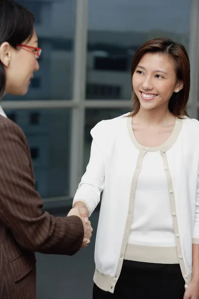 Businesswomen shaking hands Stock Image