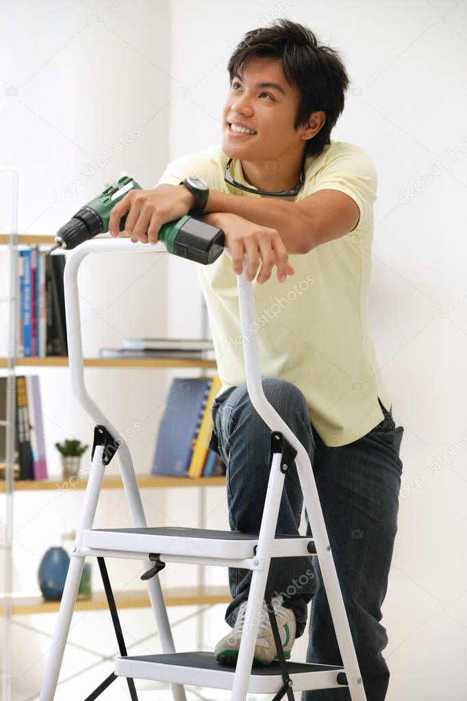 Man leaning on stepladder