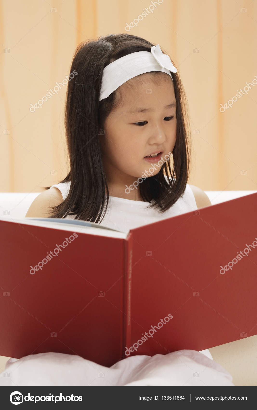 Young female child reading book Stock Photo by ©MicrostockAsia 133511864