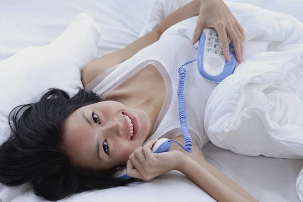 Young woman lying on bed — Stock Photo, Image