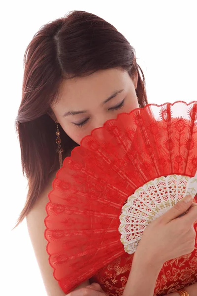 Woman holding fan in front of face — Stock Photo, Image