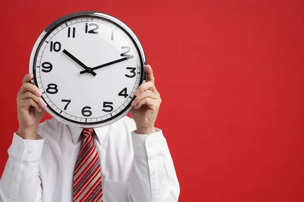 A man holds a clock Stock Photo