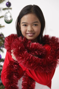 Girl with red tinsel wrap around neck  clipart