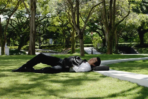 A man lies down in the park