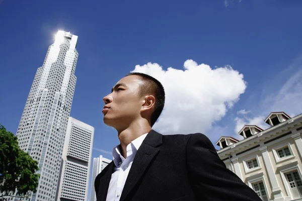A man in a suit with a skyscraper