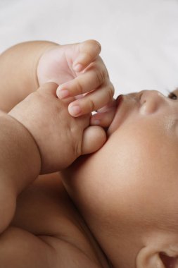 baby sucking fingers. clipart