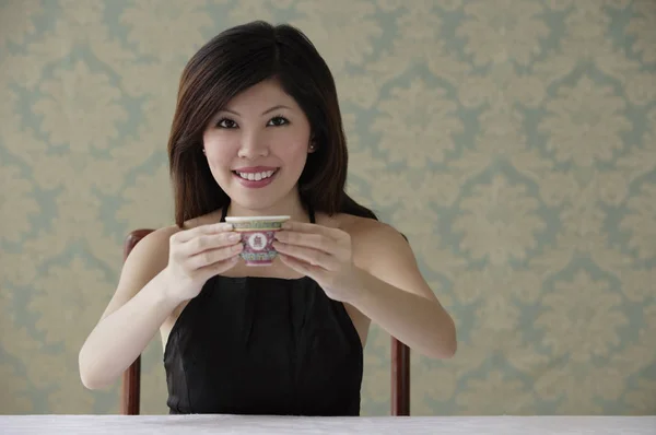 woman holding teacup