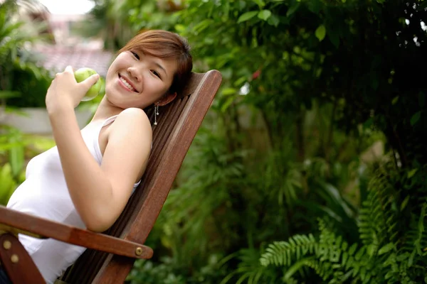 Young woman sitting on chair — Stock Photo, Image