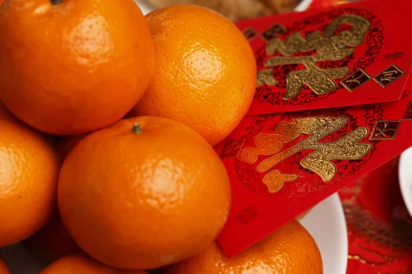 Hong bao und Orangen — Stockfoto