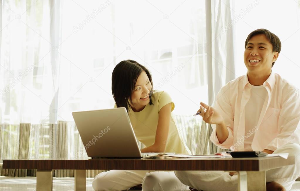 couple sitting in front of laptop