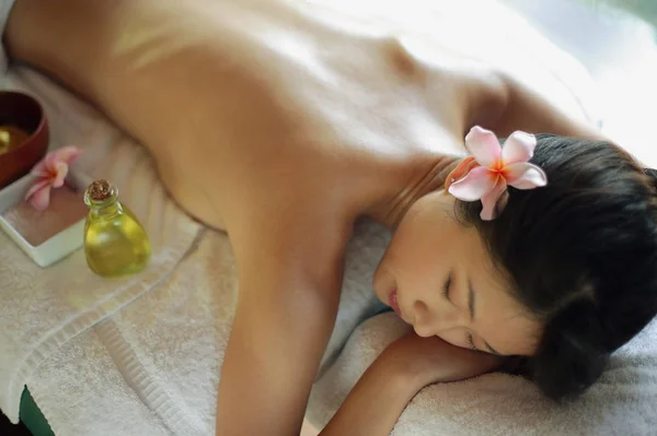 Woman lying on massage table — Stock Photo, Image