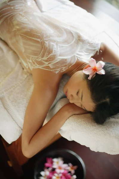 Woman lying on massage table — Stock Photo, Image