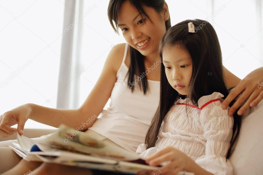 Mother and daughter, sitting side by side