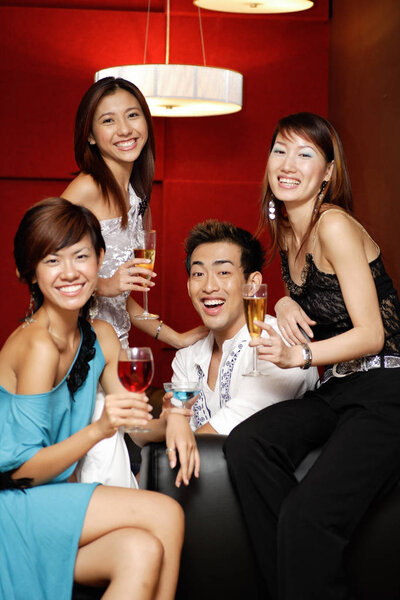 adults holding drinks