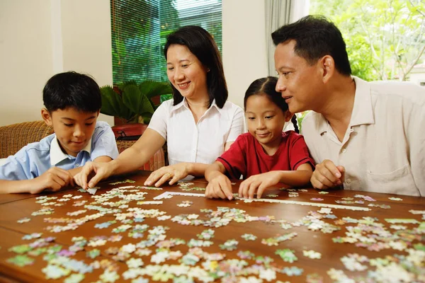 Family playing jigsaw puzzle