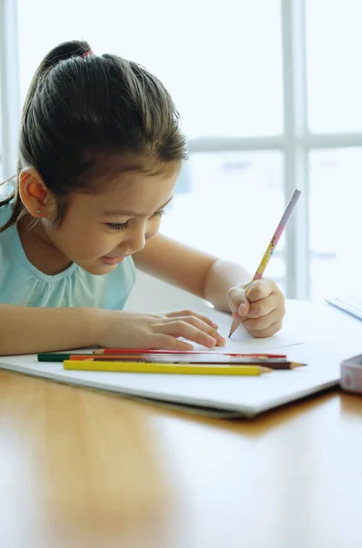 girl holding pencil