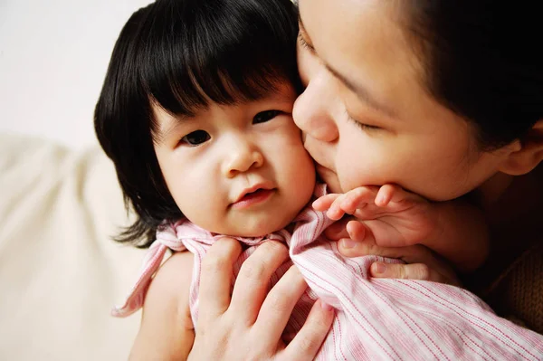 Mother kissing baby — Stock Photo, Image