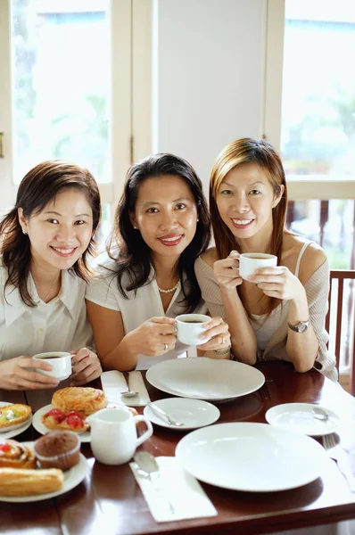 Women in cafe with cups — Stock Photo, Image