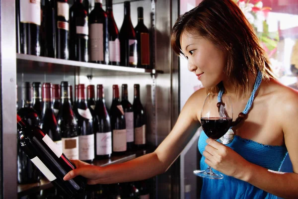 Young woman holding wine glass