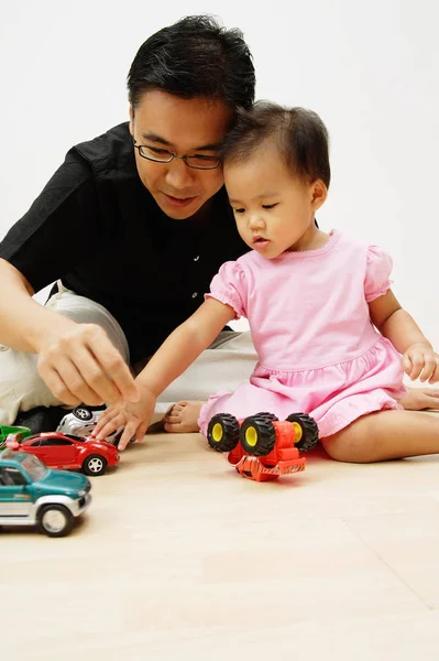 Father and mother play with daughter — Stock Photo, Image