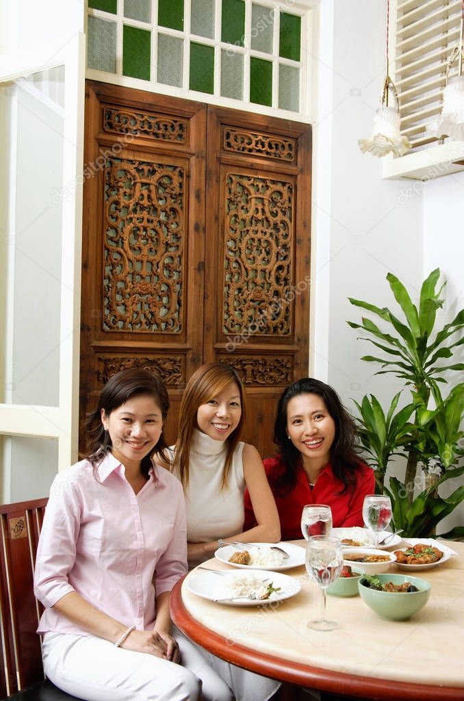 Three women at a restaurant sitting